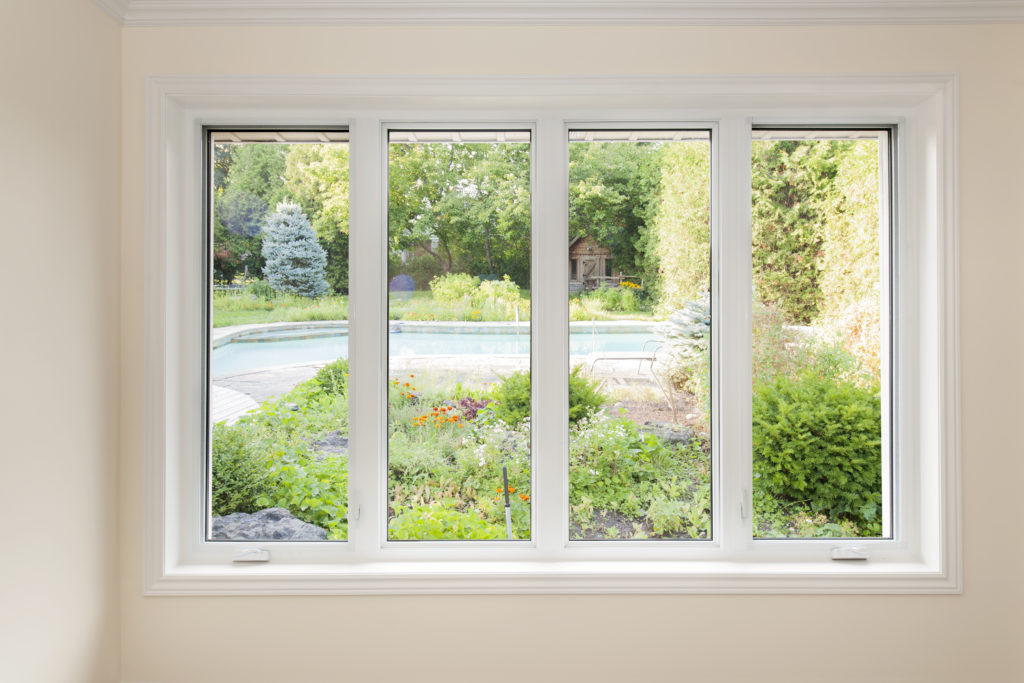 A white slider window set in a pale interior wall