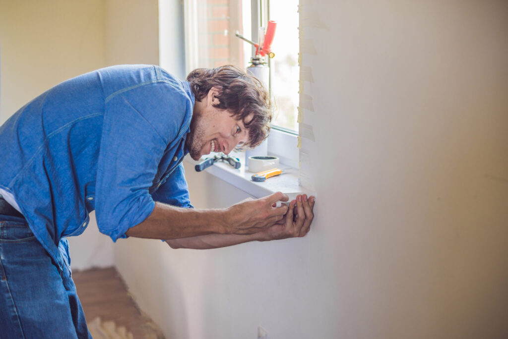 A glazier working at a window opening