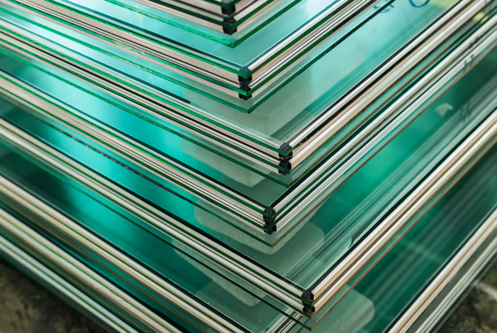 Sheets of glass stacked on edge, green at the cut edges