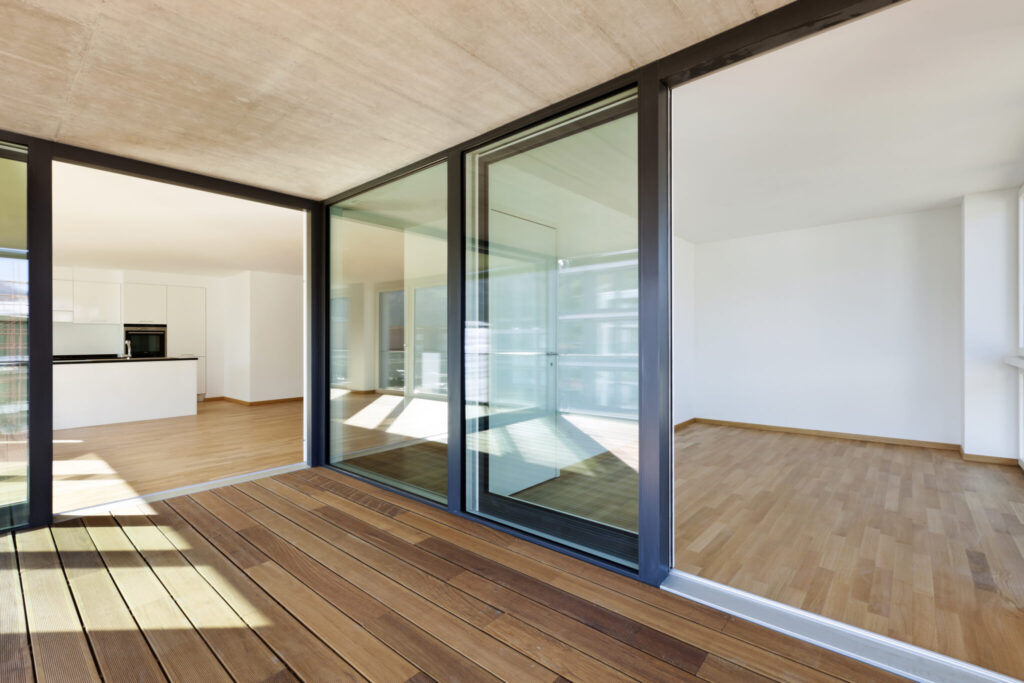 Wide sliding glass doors opening from a living room onto a patio