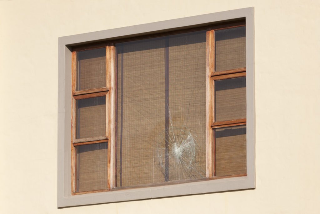 Wooden shutters folded back from a window