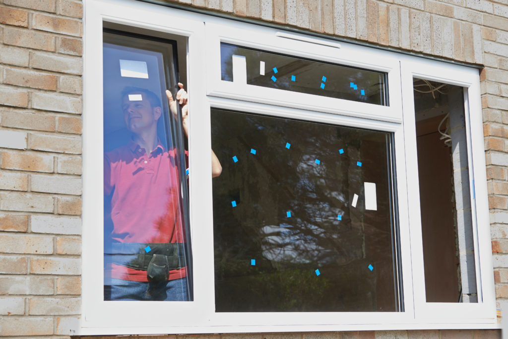 A new window unit set into an opening with sheeting behind it